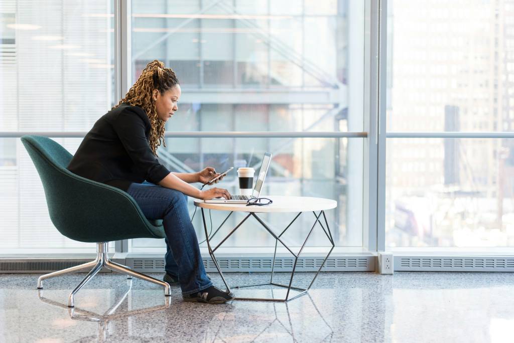 Woman sat down in front of laptop